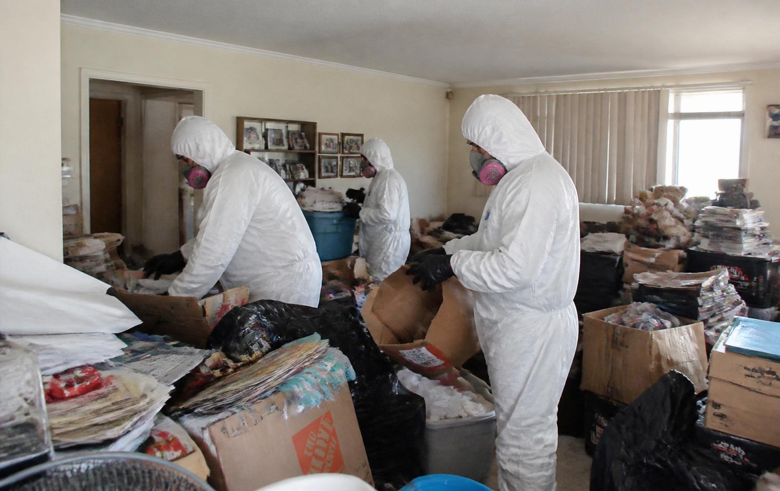 Compassionate hoarding cleanout crew clearing a cluttered Jacksonville home