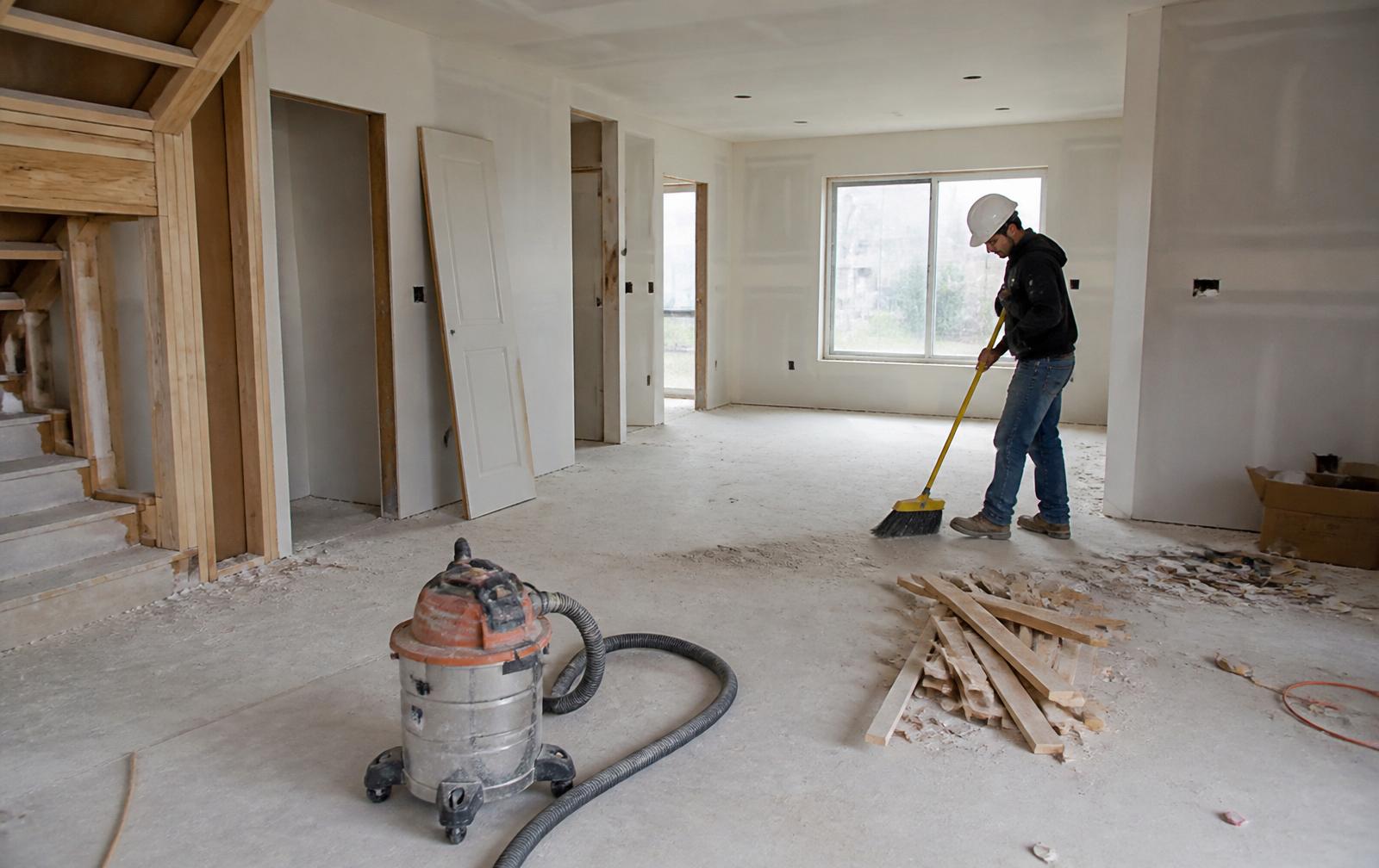Post-construction cleaning crew wiping down a new build kitchen in Jacksonville
